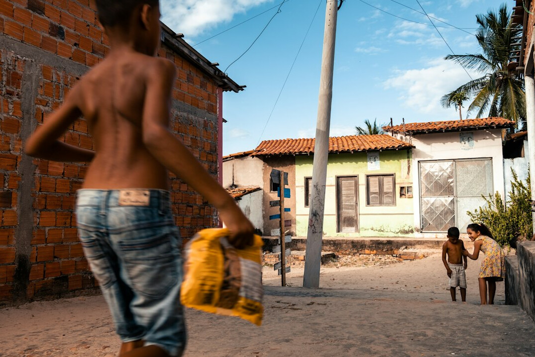 Two Brazilian people greeting each other warmly with a handshake